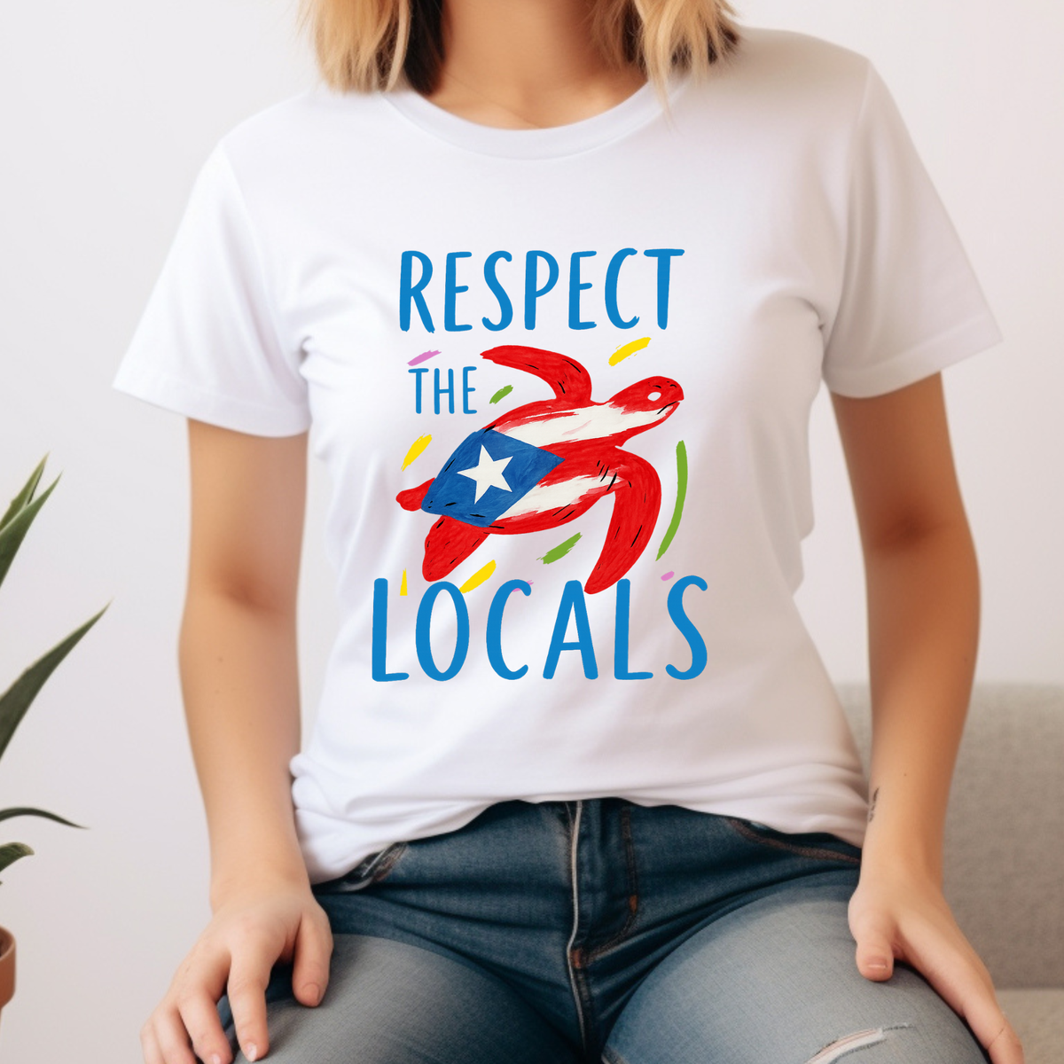 Person wearing a white t-shirt with 'Respect the Locals' design featuring a flag.