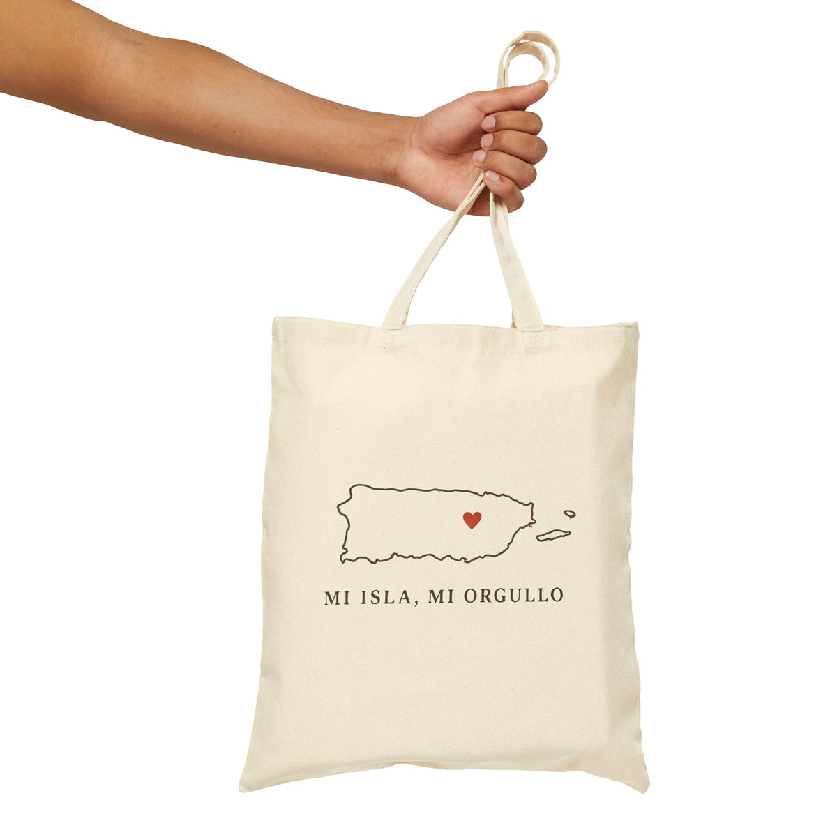 Beige tote bag with 'peace lives here' text held by a hand on a white background