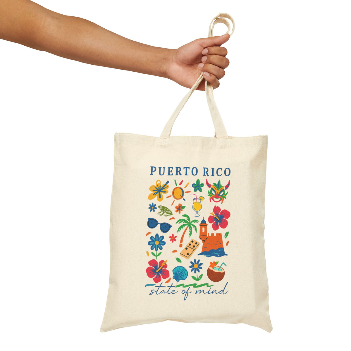 An off-white canvas tote bag with a colorful Puerto Rico graphic print, held by a person's arm against a plain white background.