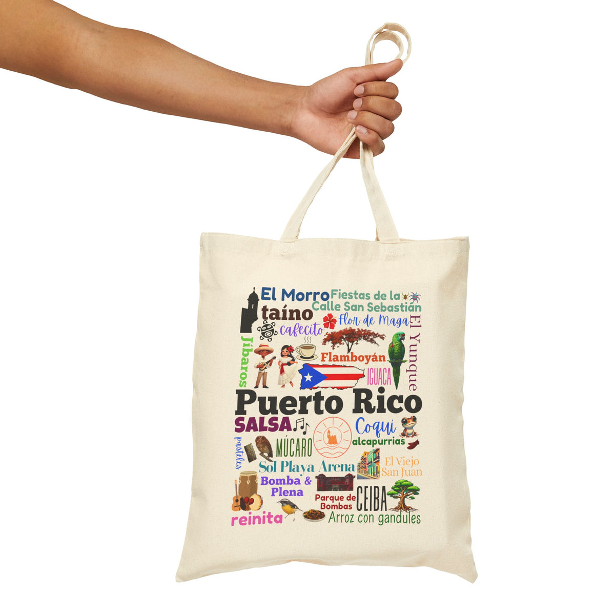 An off-white canvas tote bag with a colorful Puerto Rico-themed collage print, held by a person's hand against a plain white background.