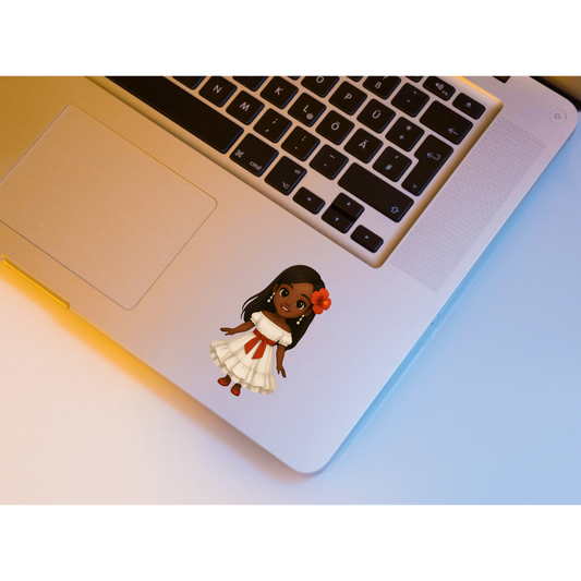 A cartoon-style vinyl sticker of a girl with dark skin, long black hair, and a white dress with a red sash, placed on the palm rest of a silver laptop.