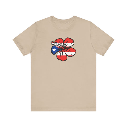 A beige crewneck t-shirt featuring a graphic of a hibiscus flower filled with the Puerto Rican flag pattern on the chest, displayed against a solid white background.