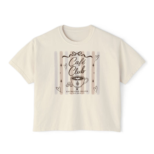 An off-white short-sleeve crop top t-shirt featuring a 'Cafe Club' graphic print on the front with a coffee cup illustration and hearts.