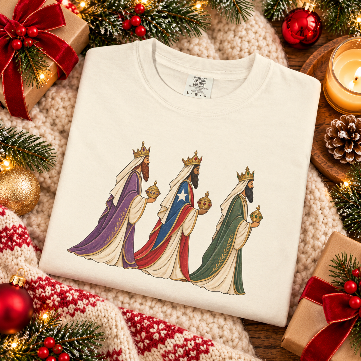 Festive holiday flat lay of folded Ivory Reyes Magos tee