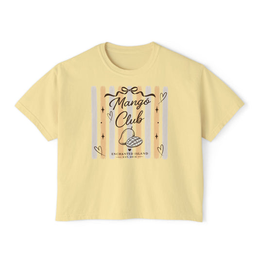A pale yellow short-sleeve t-shirt with a graphic on the front that reads 'Mango Club' and 'Enchanted Island' with decorative hearts and stripes, shown on a plain white background.